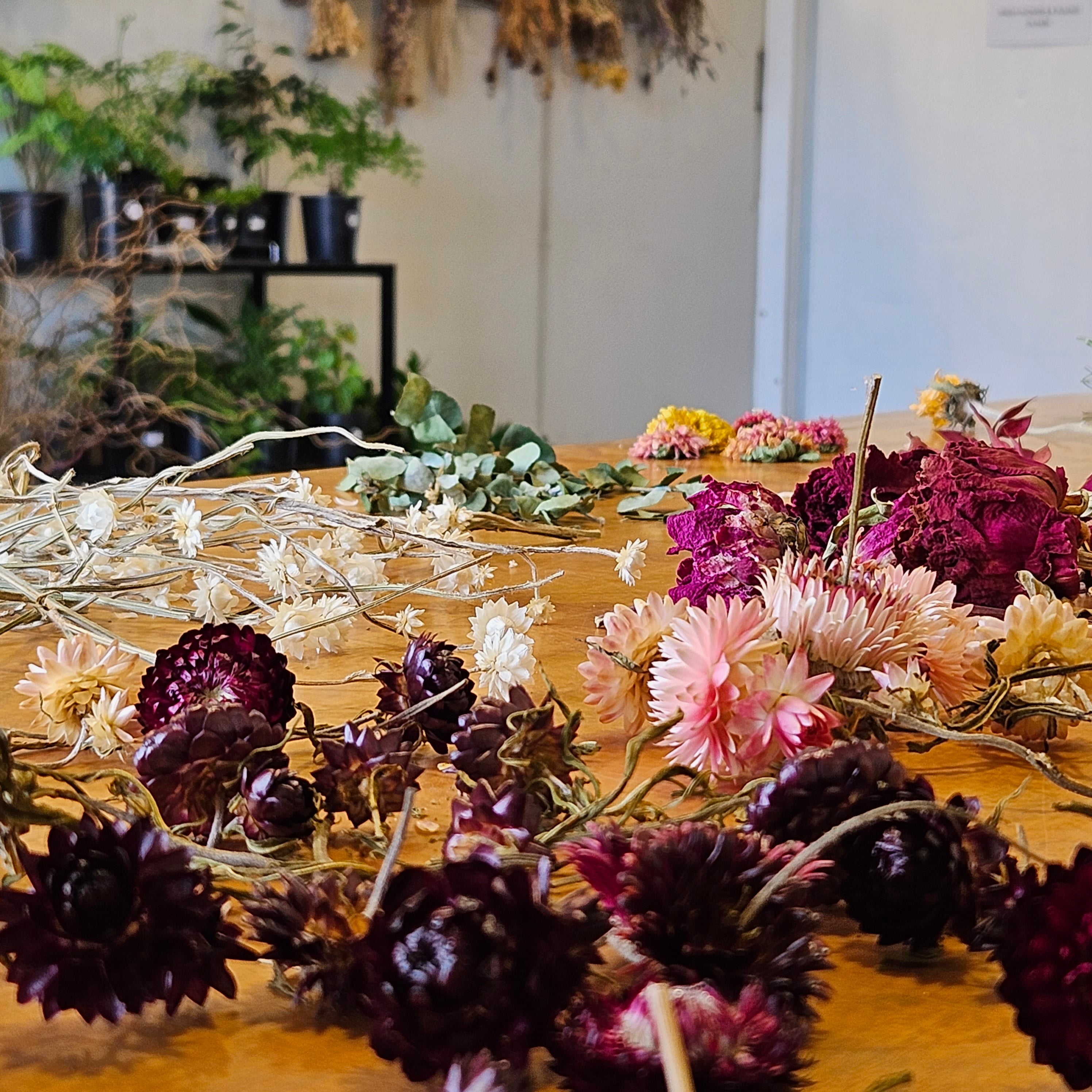 A selection of dried flowers on a table for a dried floral workshop class at Nelson Flower Company.