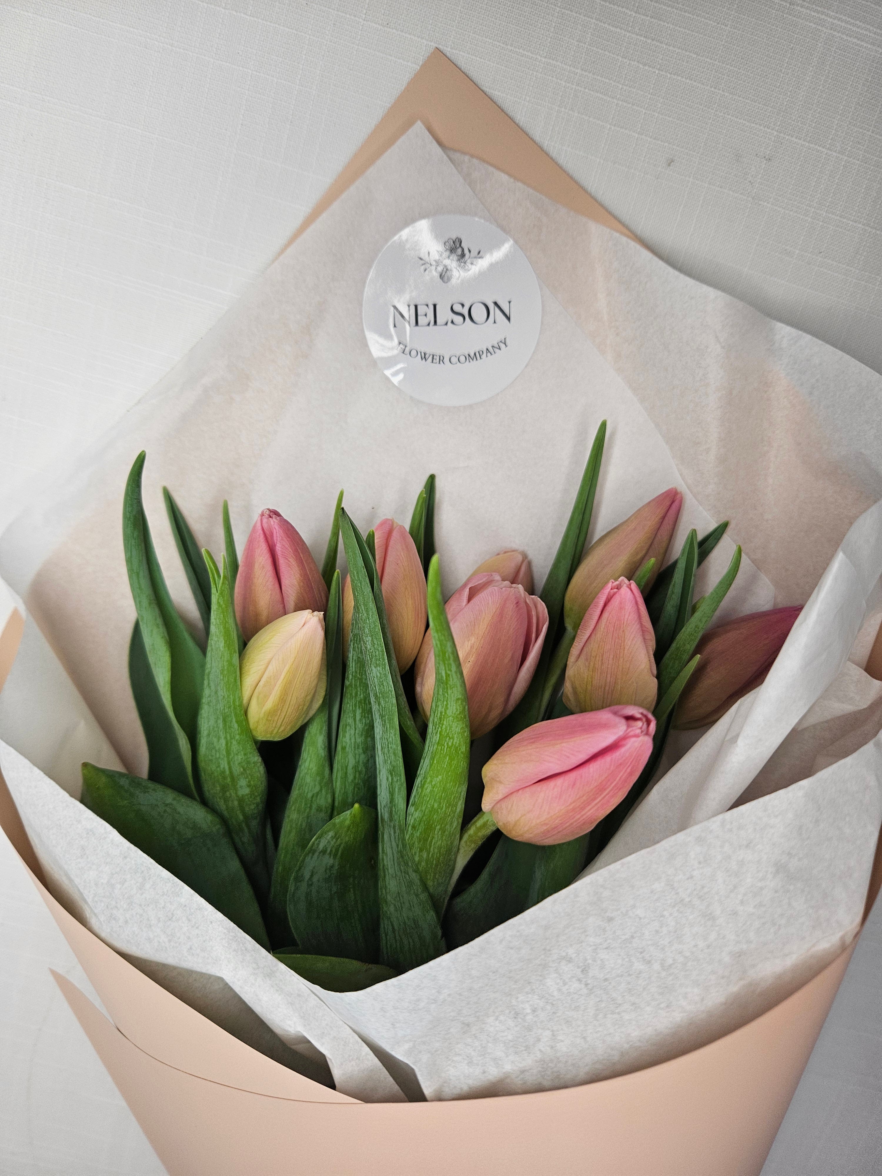 Soft pink Market Tulips wrapped in champagne rose gold paper.