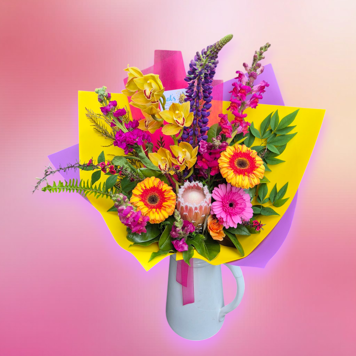 Petal Parade - Bright & Bold floral bouquet made with a variety of brightly coloured flower and foliage, wrapped in matching paper.
