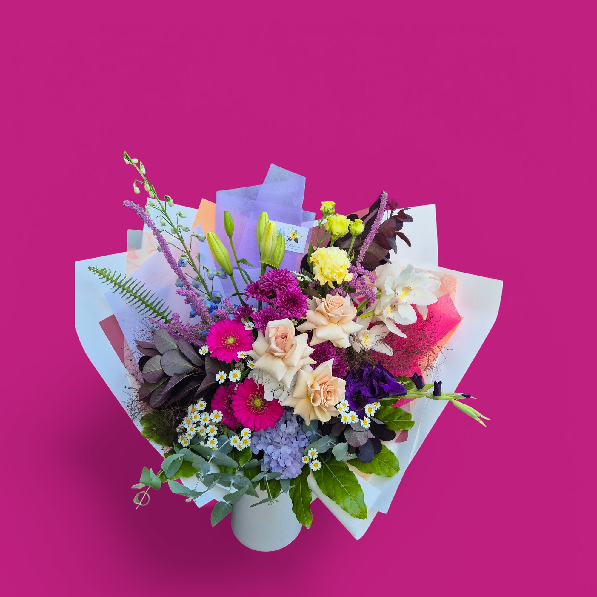 Petal Parade - Bright & Bold floral bouquet made with a variety of brightly coloured flower and foliage, wrapped in matching paper.
