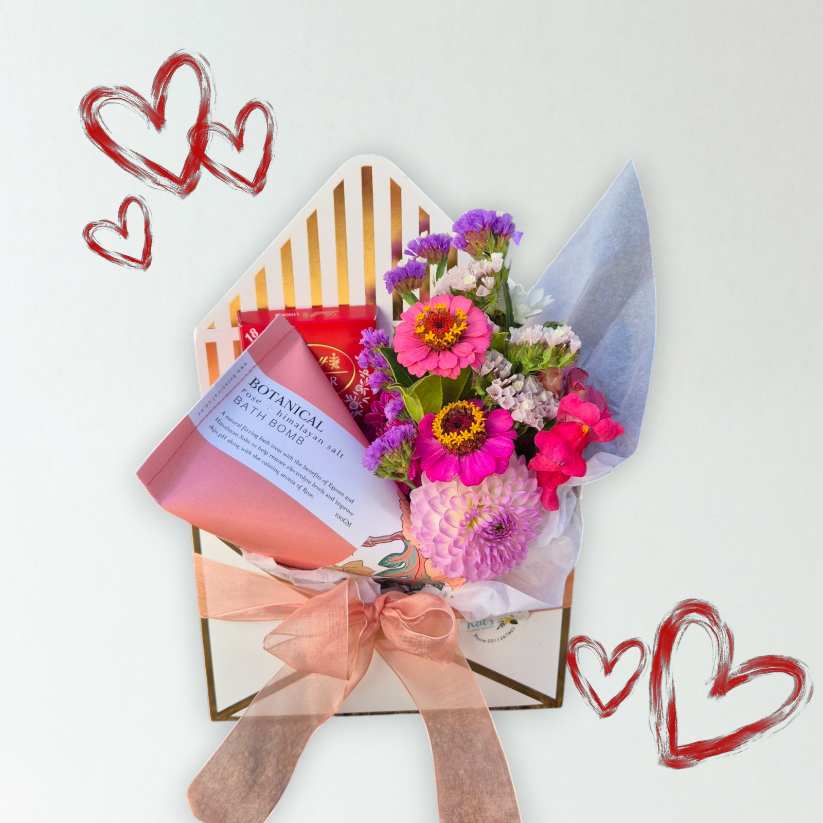 Envelope of Love & Blooms gift box containing a small bunch of flowers, a Botanical Bath Bomb and box of Lindt chocolate. Perfect for Mother&