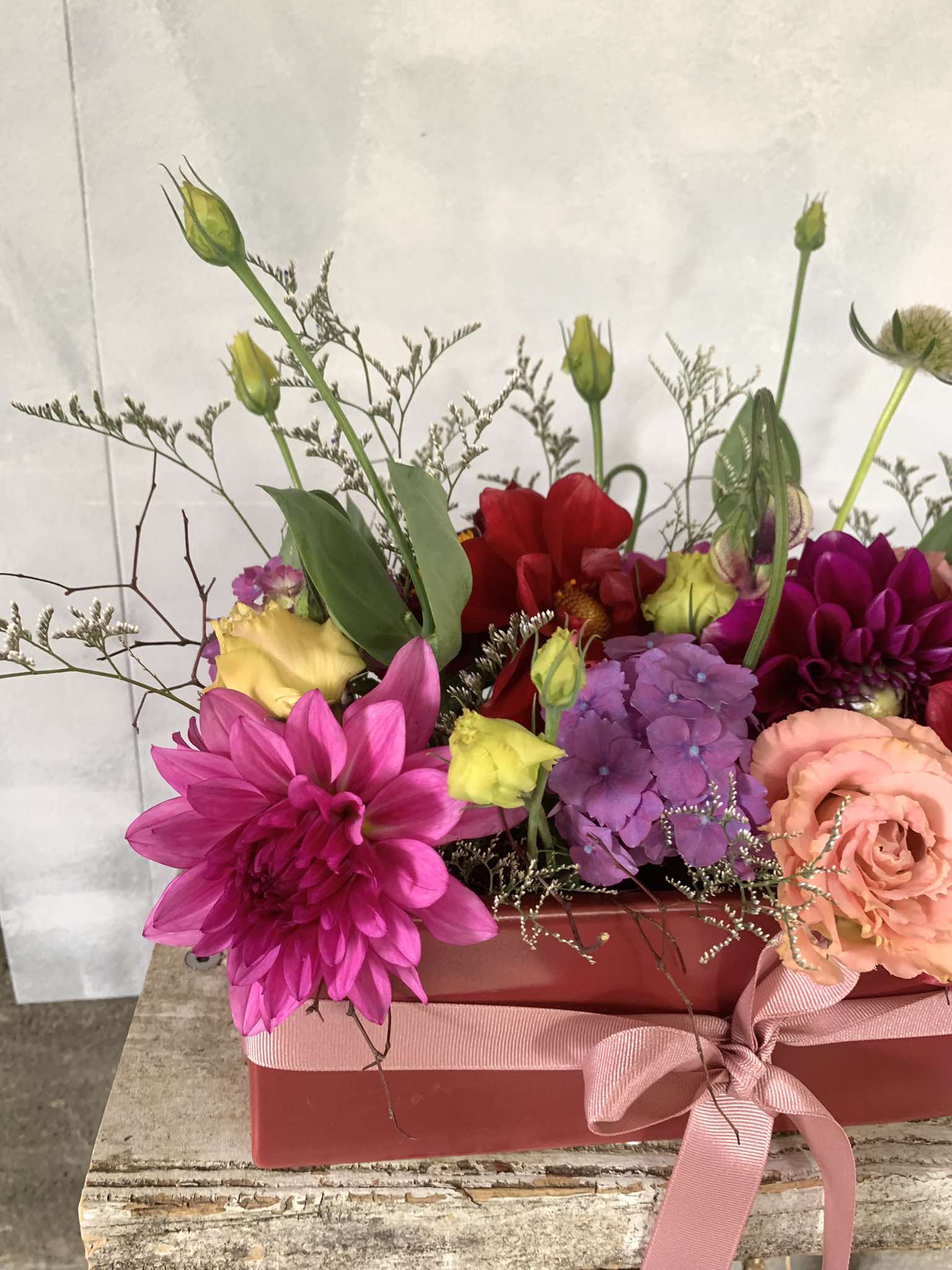 Be Mine floral arrangement made with pink, red and purple flowers and green foliage, presented in a red vase tied with matching ribbon. Perfect for Valentines Day!