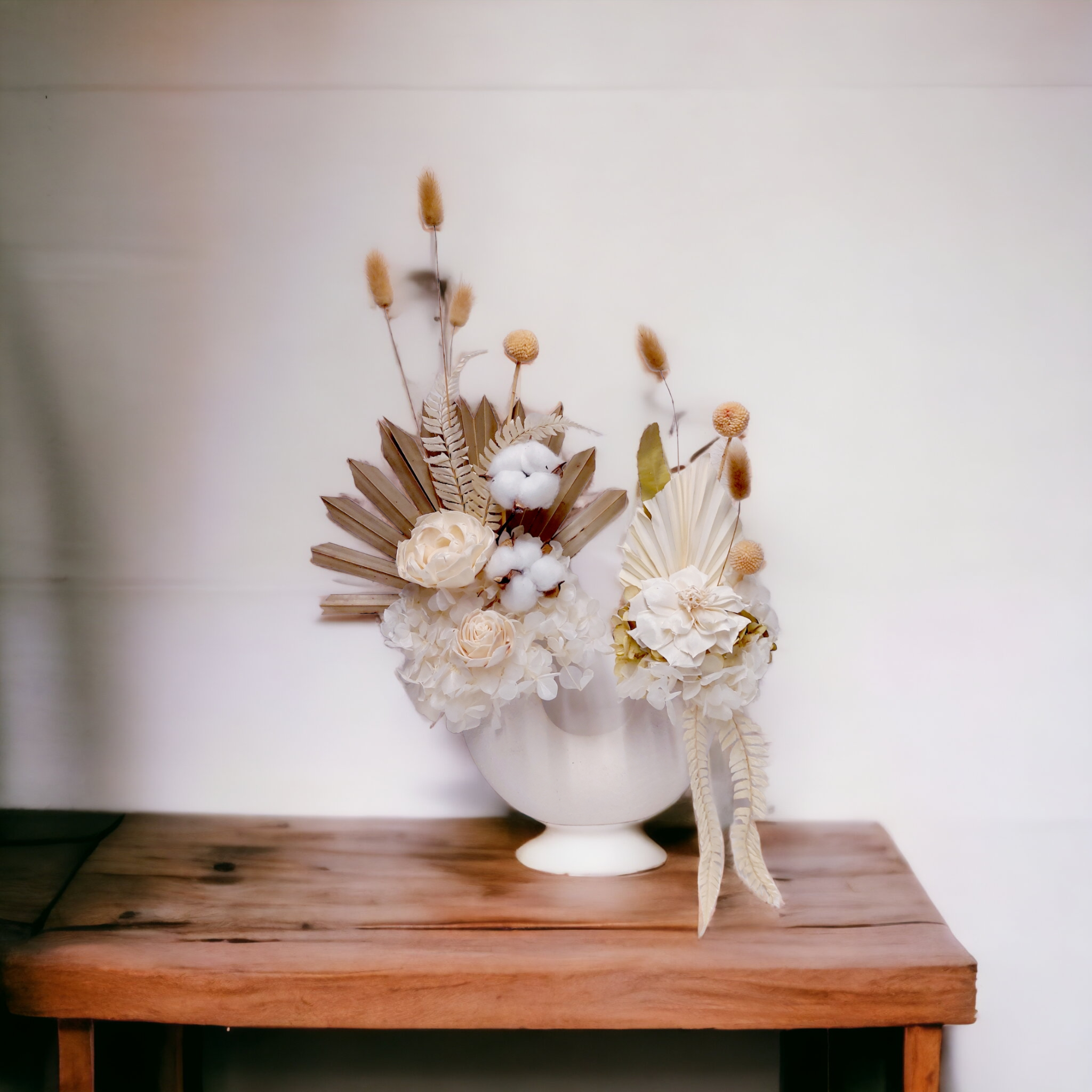 Eternal Petals bouquet with neutral-toned flowers and foliage, arranged in a U-shaped vase with two openings.