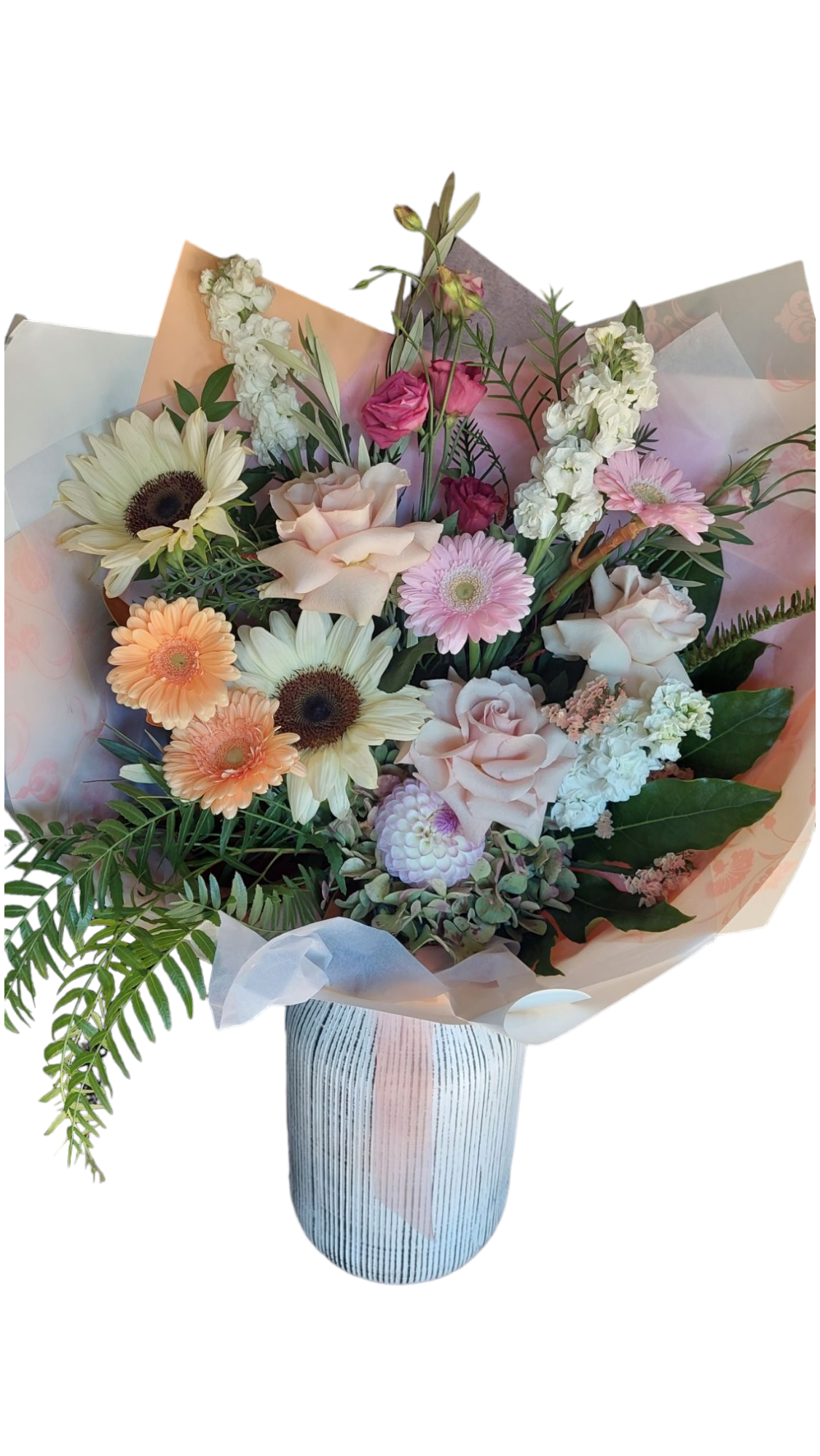 Sympathy Flowers bouquet in Large size made with soft orange, yellow, white and pink flowers and foliage, wrapped in white and peach paper.