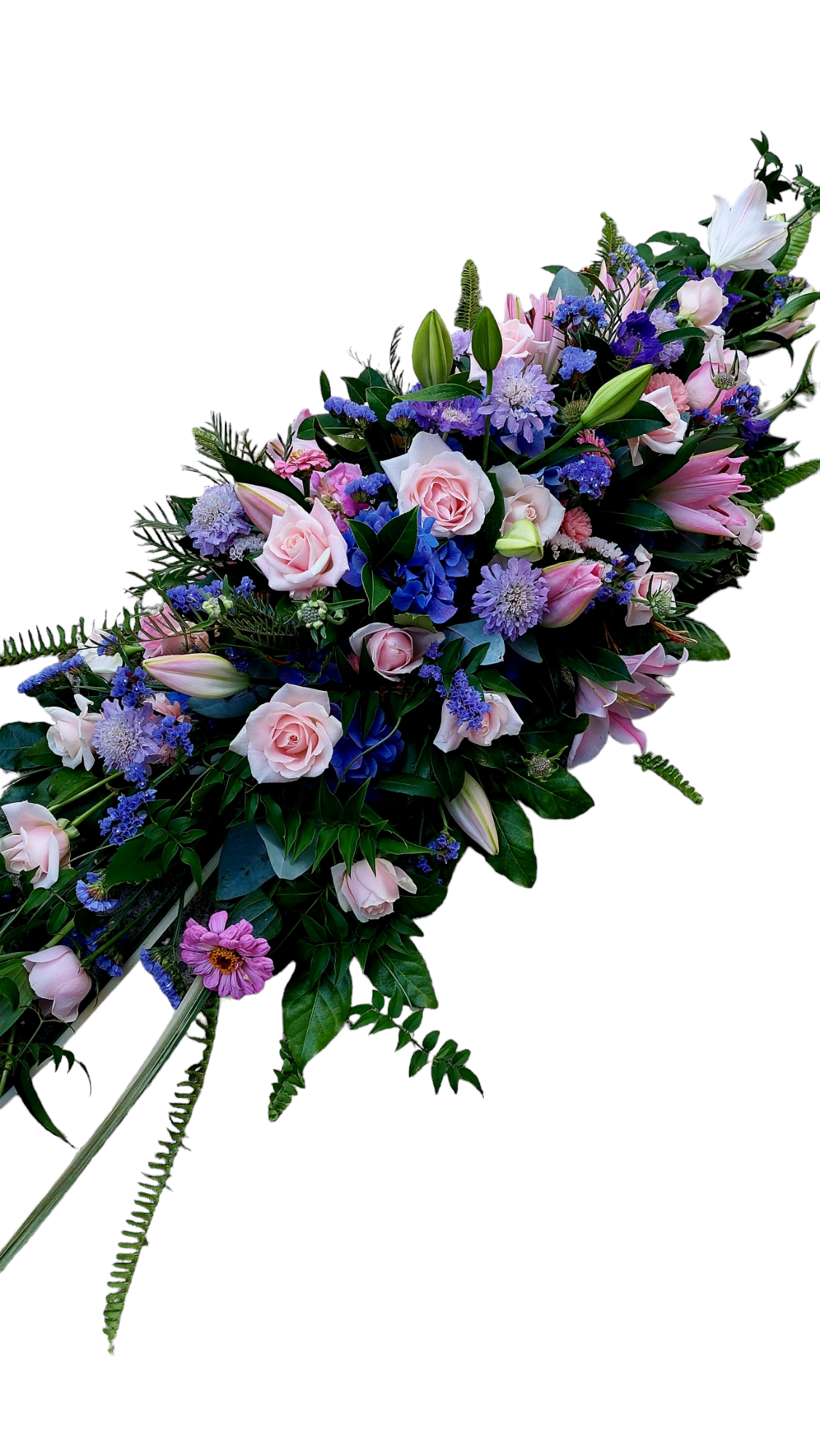 Bright Casket Spray for funerals and memorials made with an assortment of blue, purple and pink flowers and foliage.