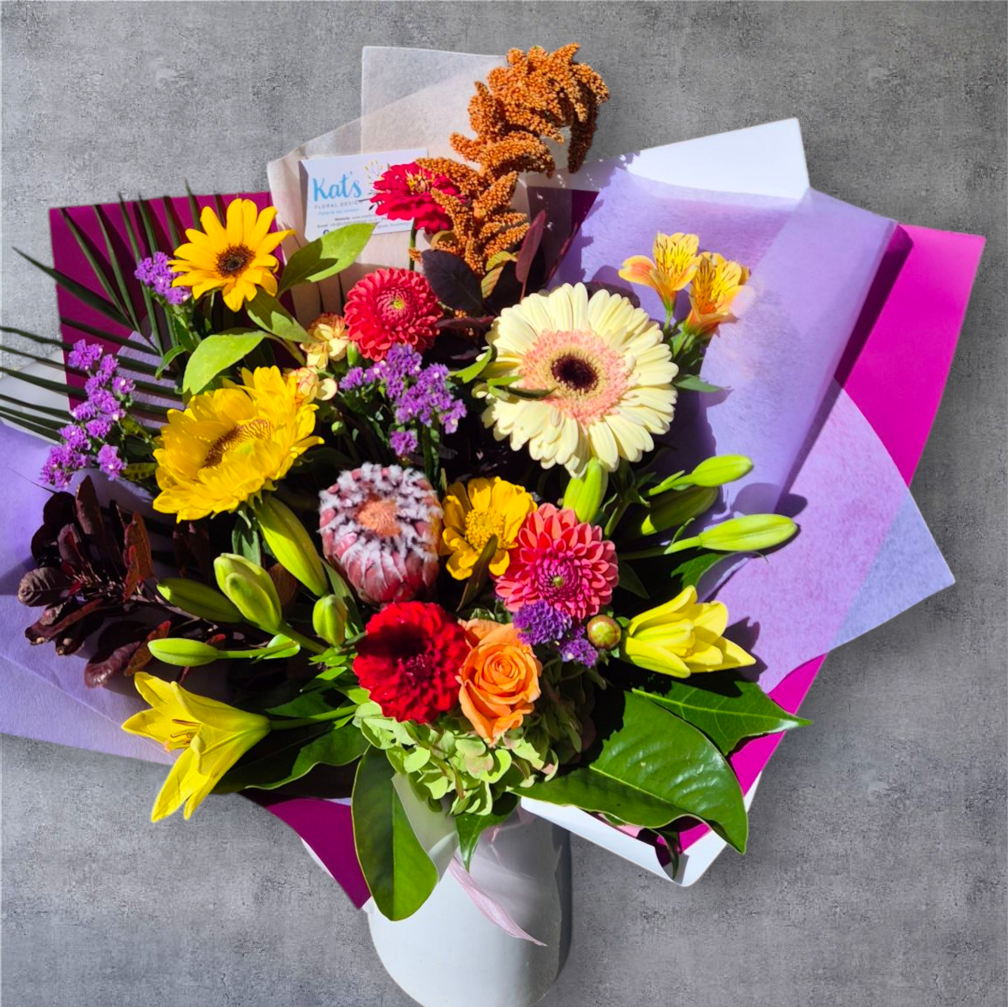 Petal Parade - Bright & Bold floral bouquet made with a variety of brightly coloured flower and foliage, wrapped in matching paper.