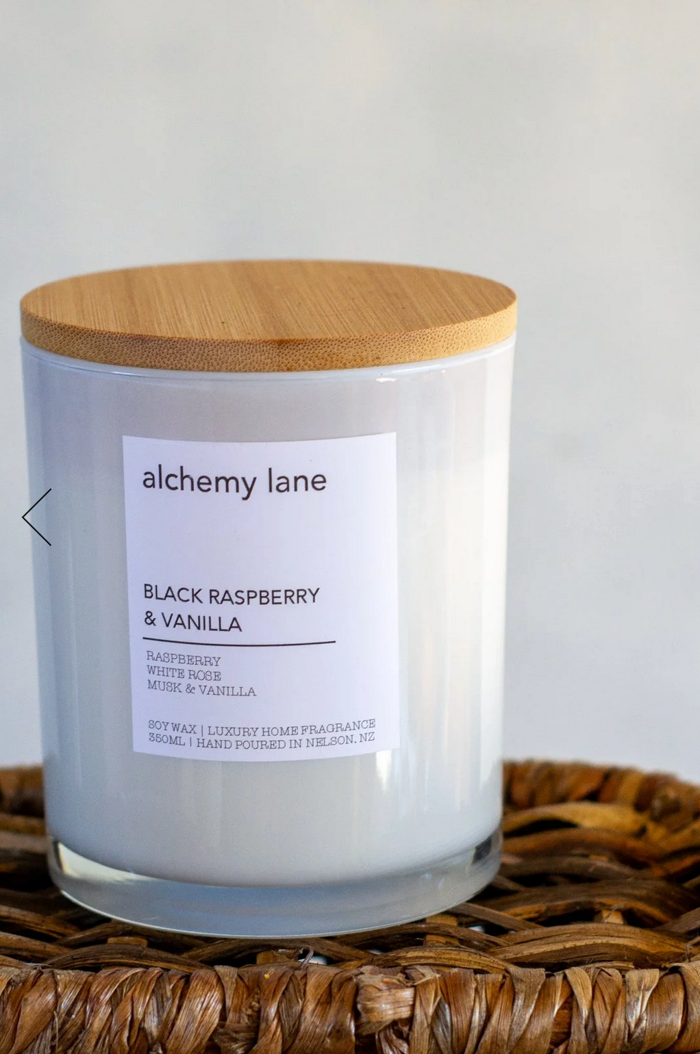 A candle made by Alchemy Lane, in the Black Raspberry & Vanilla scent.