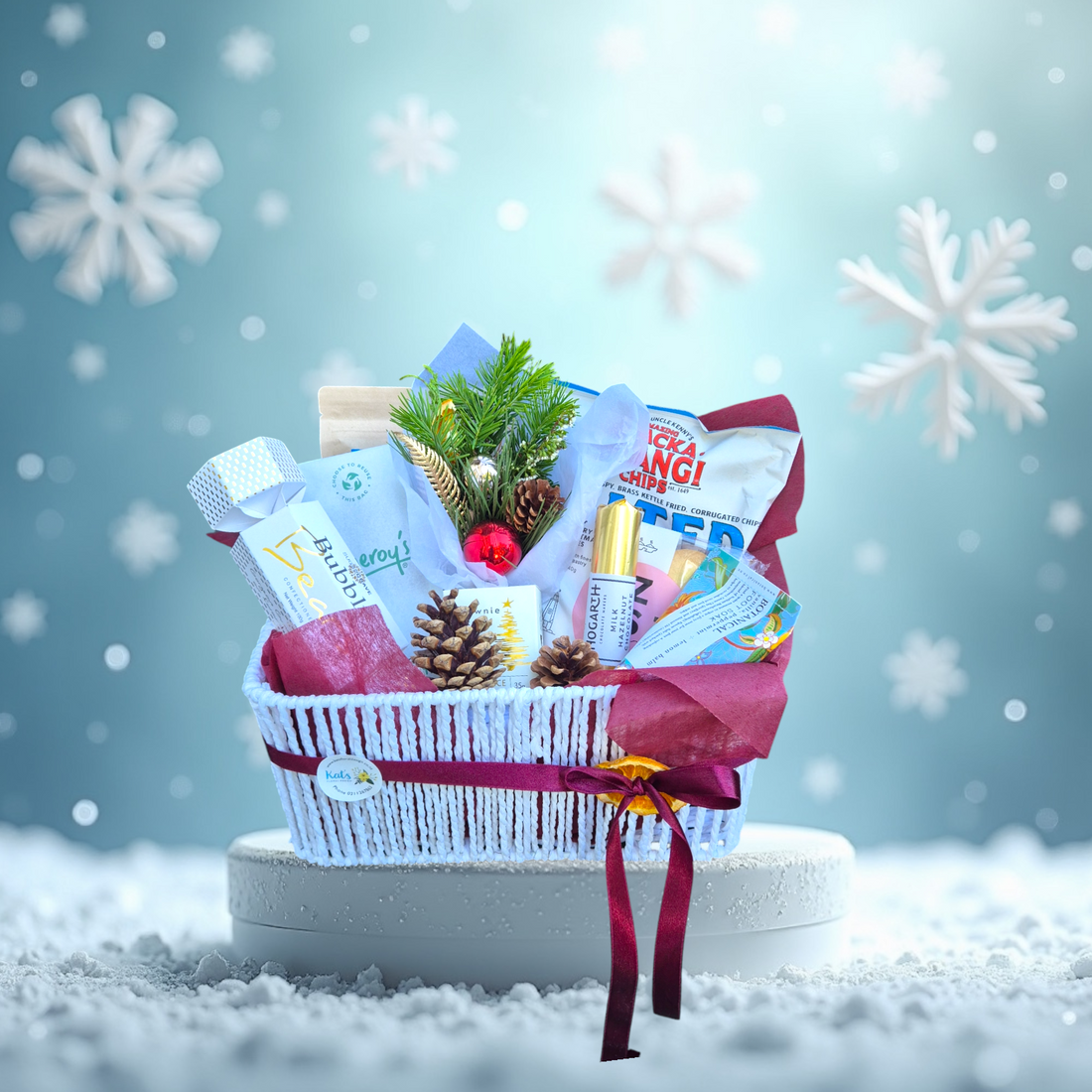 Festive Favourites Basket gift hamper filled with local Nelson treats and a floral posy made with festive flowers, presented in a white gift basket tied with a red ribbon.