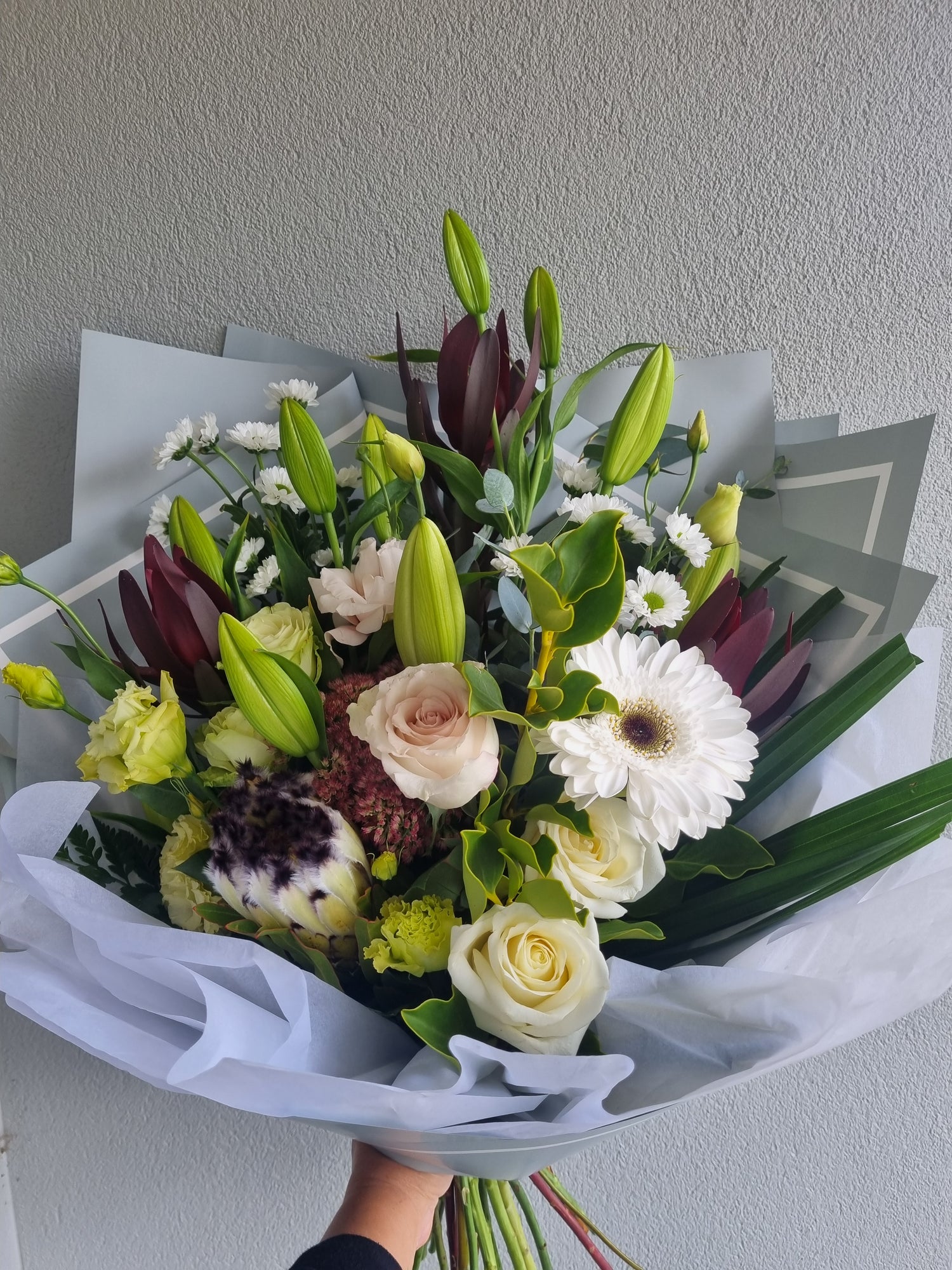 Naturally Neutral floral arrangement by Valley Bloom, with soft white and pastel coloured flowers and green foliage.