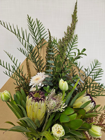 Market Bunch bouquet of neutral coloured flowers and foliage, wrapped in kraft paper.