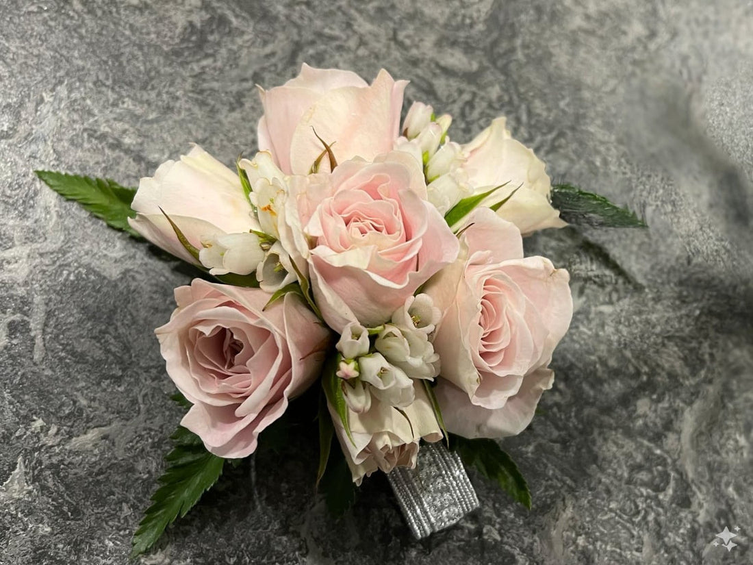 Corsage Solo made with soft pink roses and silver ribbon, perfect for school balls.