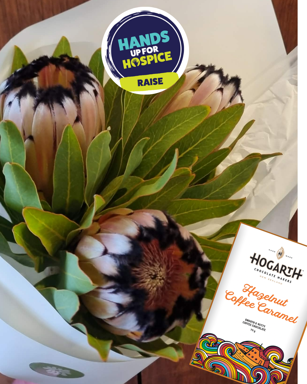 Protea Trio with Chocs bouquet of three pink and black protea flowers with green foliage, wrapped in white paper and gifted with a bar of Hogarth&