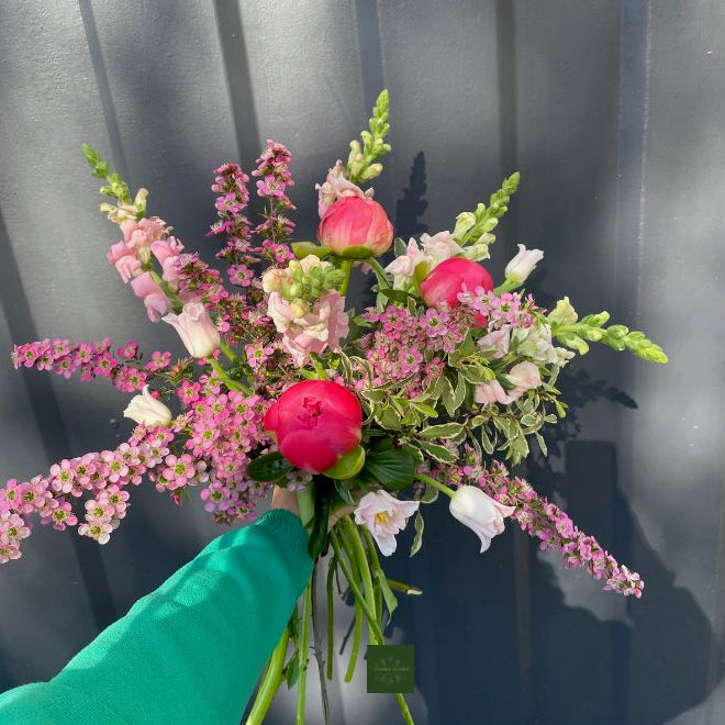 An example of what your Seasonal Bunch from Flora Flora could look like. Bright pink flowers with green foliage.