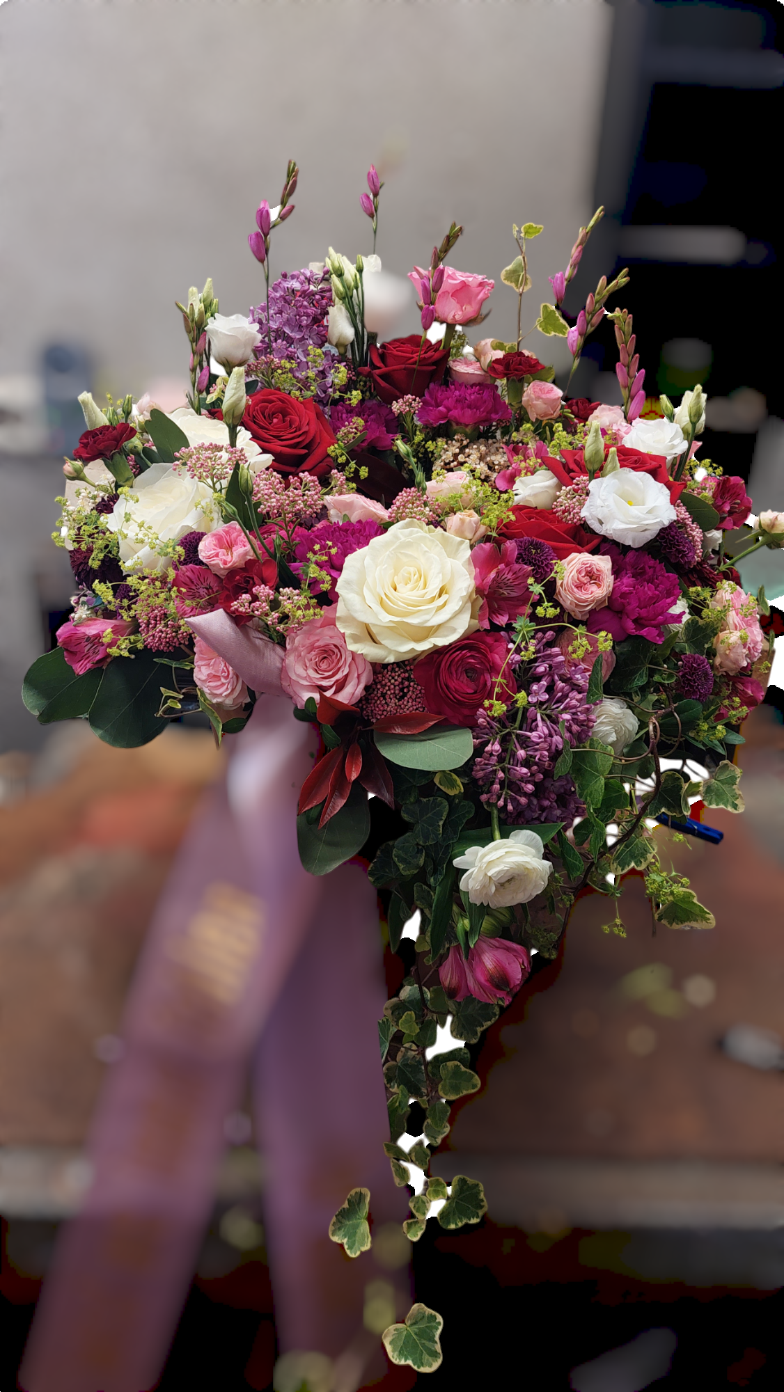 Memorial Urn Arrangement for funerals made with vibrant pink, red and purple flowers and foliage.