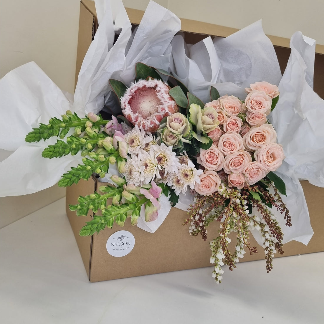 Soft & Sweet Fresh Flower Box, with greenery in a cardboard box with white tissue paper.