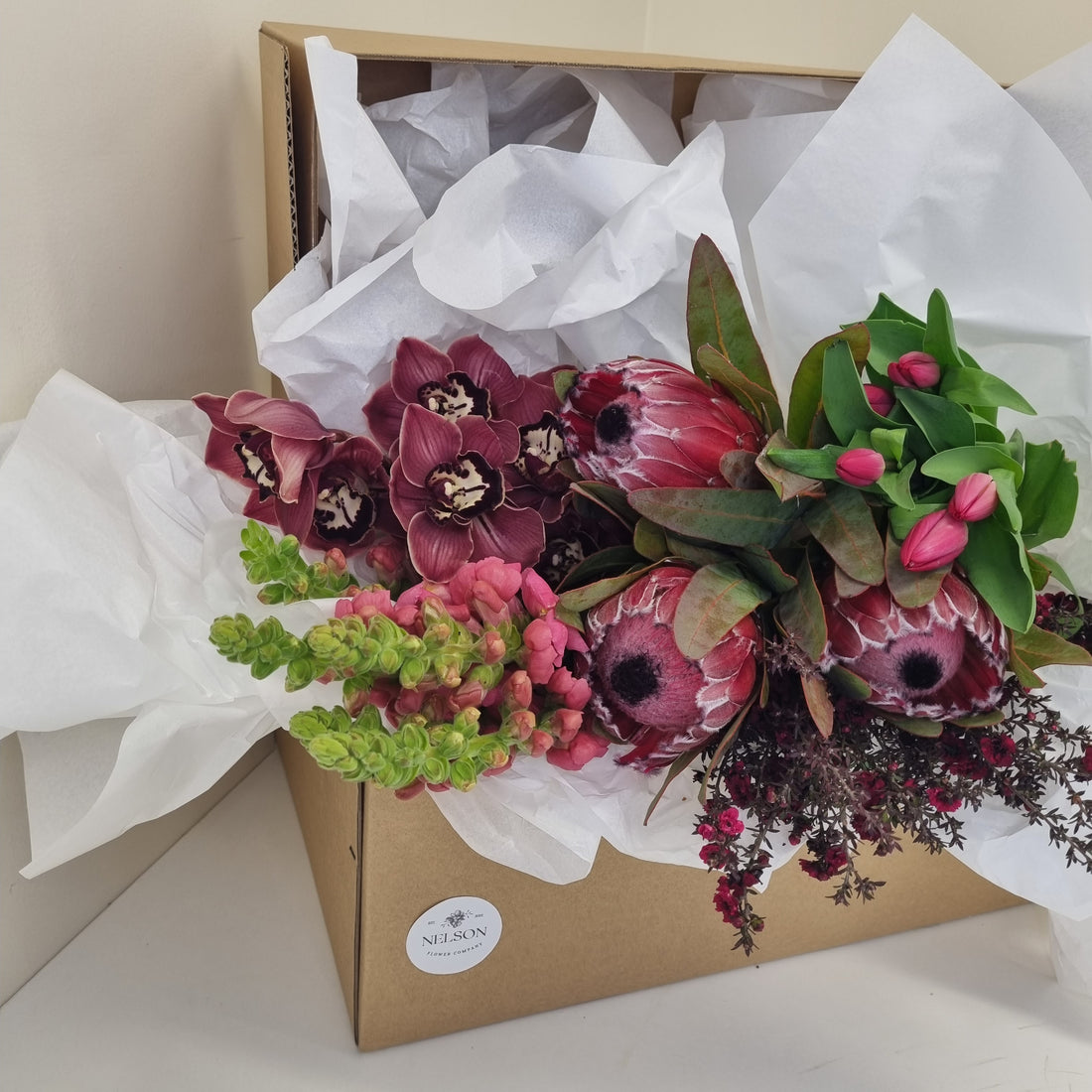 Wild &amp; Romantic Fresh Flower Box, with greenery in a cardboard box with white tissue paper.