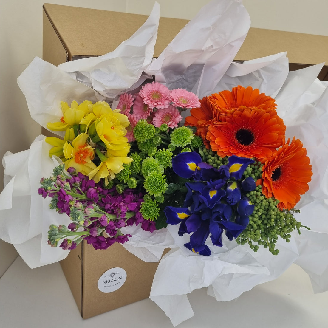 Bold &amp; Beautiful Fresh Flower Box, with greenery in a cardboard box with white tissue paper.
