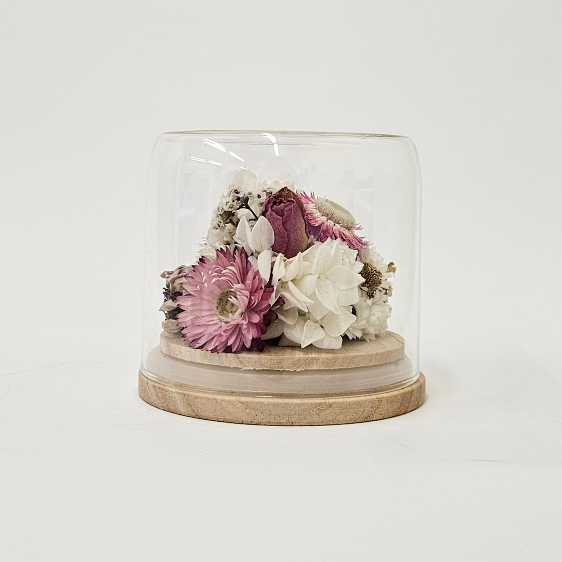 Floral Dome Kit with purple and white dried flower upon wooden base.