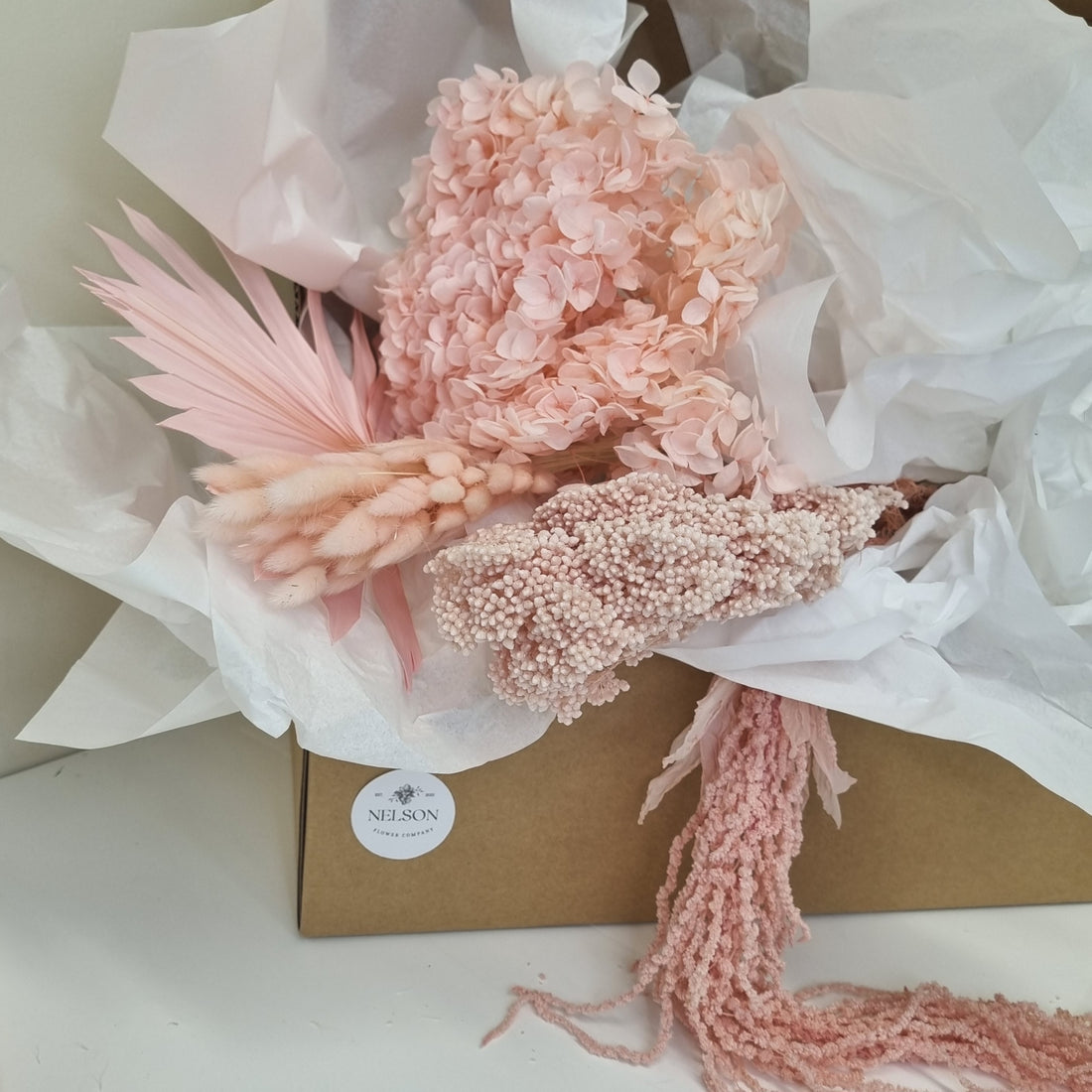 Blush Baby Dried Flower Box in cardboard box with white tissue paper.