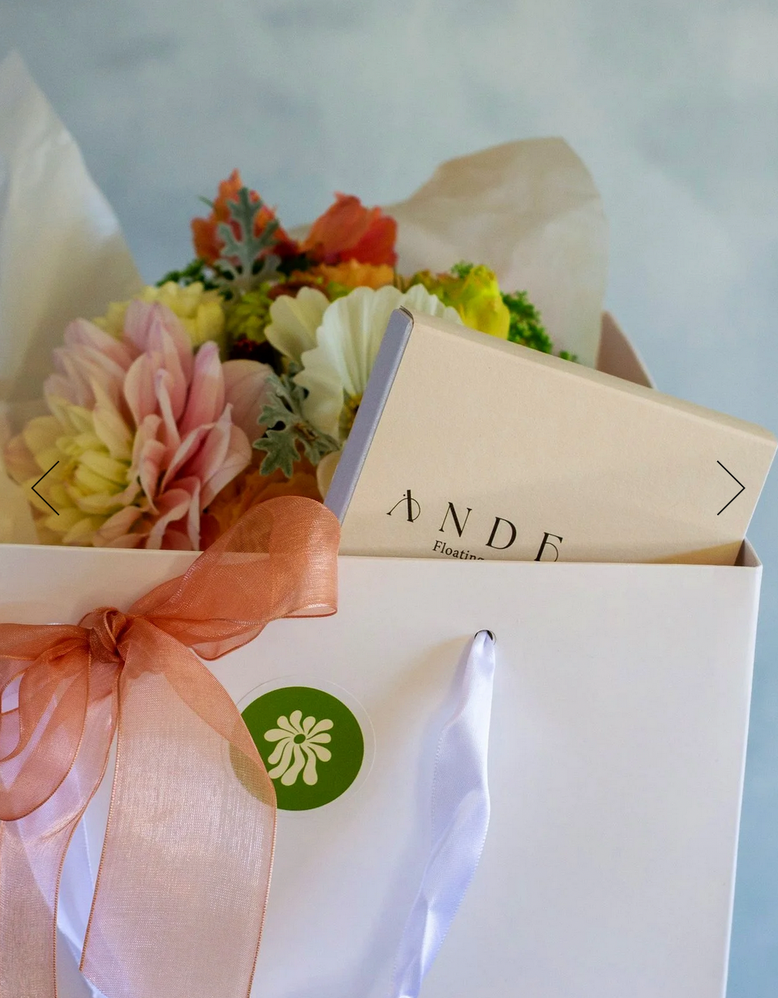 Sympathy Gift Box complete with a pastel posie/bouquet and a floating wish paper kit, presented in a white gift bag with matching ribbon.