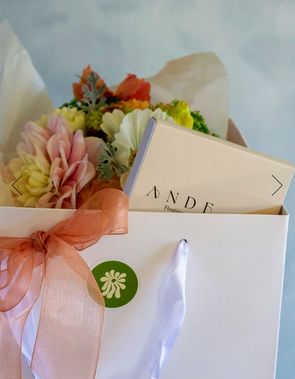 Sympathy Gift Box complete with a pastel posie/bouquet and a floating wish paper kit, presented in a white gift bag with matching ribbon.
