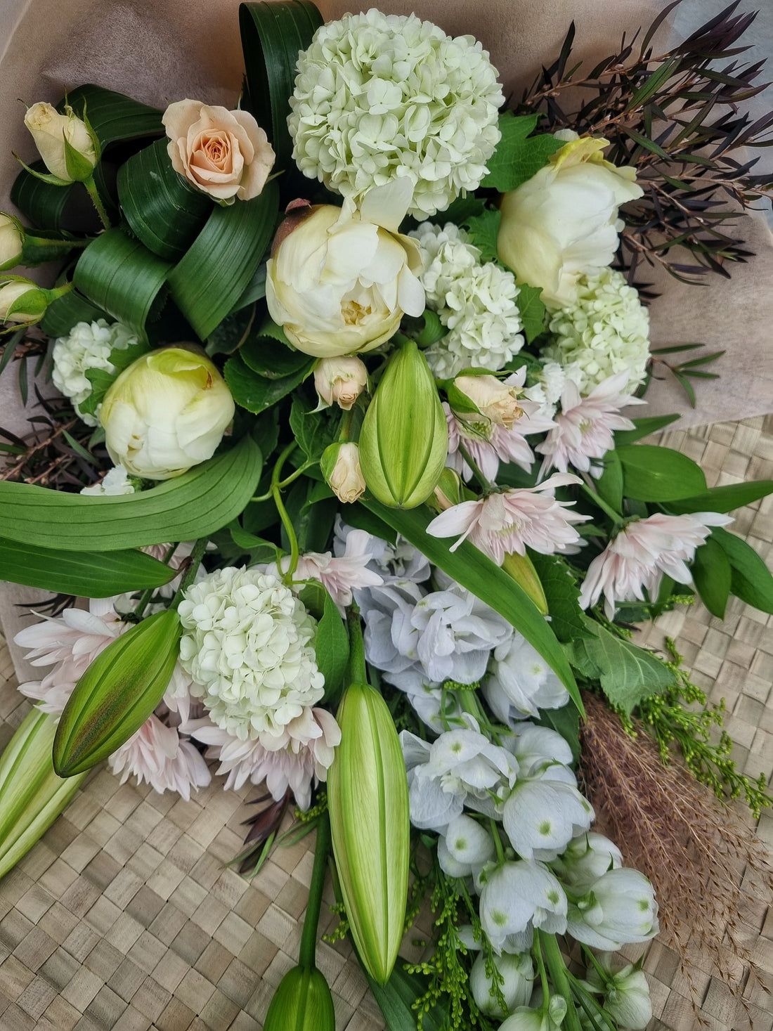 Naturally Neutral floral arrangement by Valley Bloom, with soft white and pastel coloured flowers and green foliage.